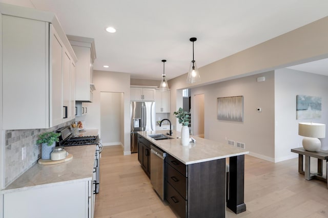 kitchen featuring a sink, stainless steel appliances, white cabinetry, light wood-style floors, and recessed lighting