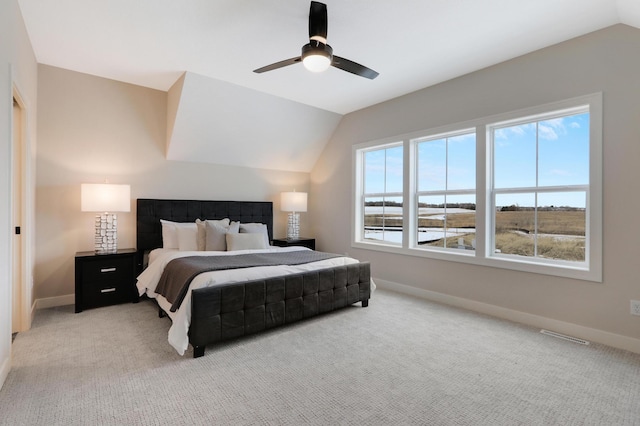 bedroom featuring vaulted ceiling, baseboards, light carpet, and a ceiling fan