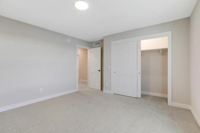 unfurnished bedroom featuring carpet flooring, a closet, and baseboards