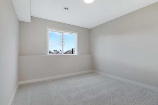 carpeted spare room with baseboards