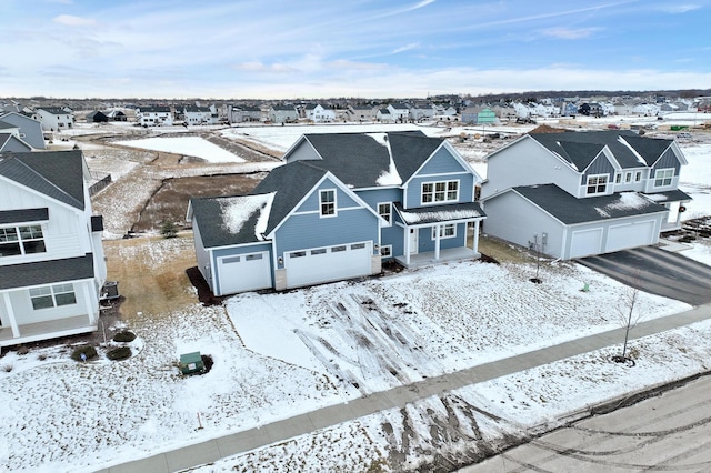 snowy aerial view with a residential view