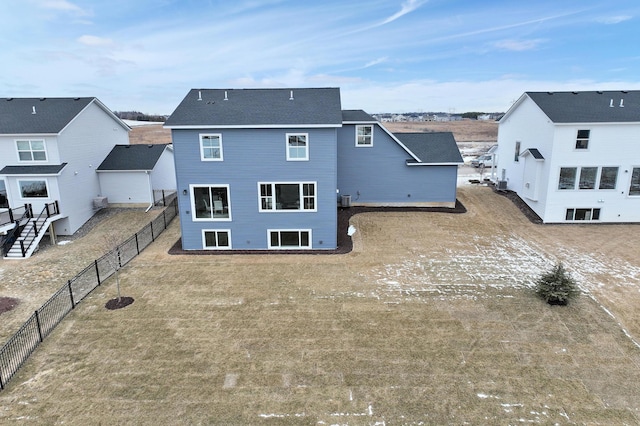 rear view of property featuring a fenced backyard