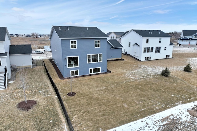 back of property featuring a residential view and a shingled roof