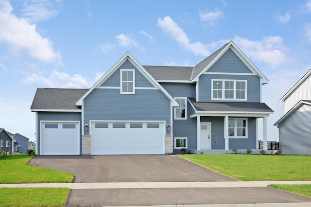 9568 63rd St S, Cottage Grove, MN 55016 - view of front of home with driveway, a front yard, stone siding, and a garage