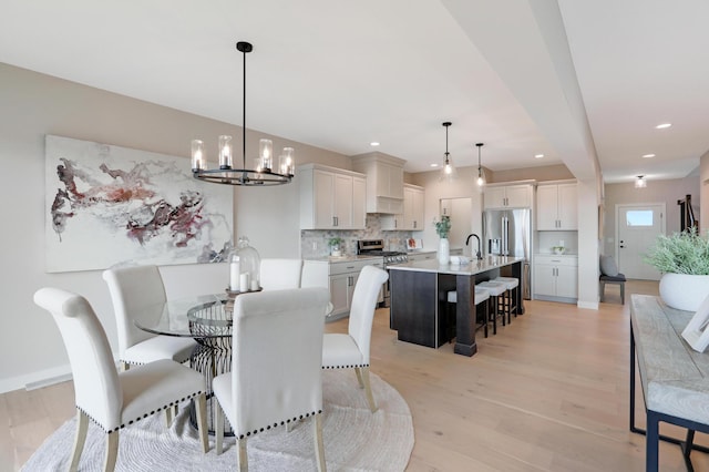 9568 63rd St S, Cottage Grove, MN 55016 - dining space featuring light wood-type flooring, a chandelier, recessed lighting, and baseboards