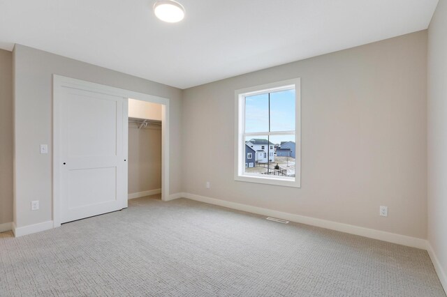 9568 63rd St S, Cottage Grove, MN 55016 - unfurnished bedroom featuring light carpet, baseboards, and a closet