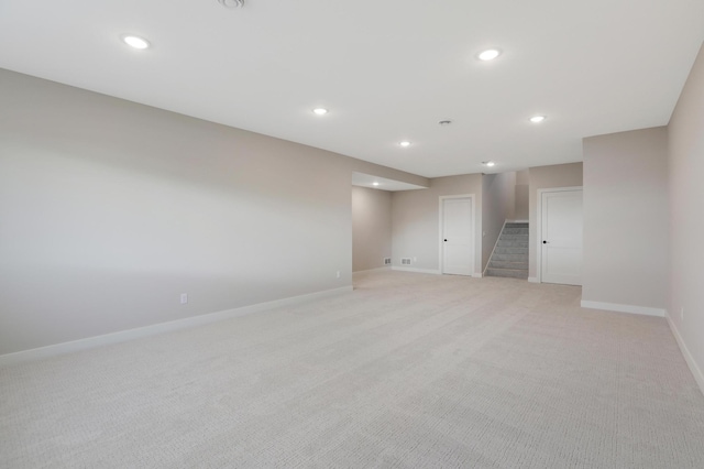 9568 63rd St S, Cottage Grove, MN 55016 - unfurnished room with stairway, light carpet, baseboards, and recessed lighting