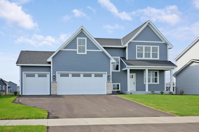9568 63rd St S, Cottage Grove, MN 55016 - view of front of home featuring driveway, a front lawn, covered porch, stone siding, and a garage