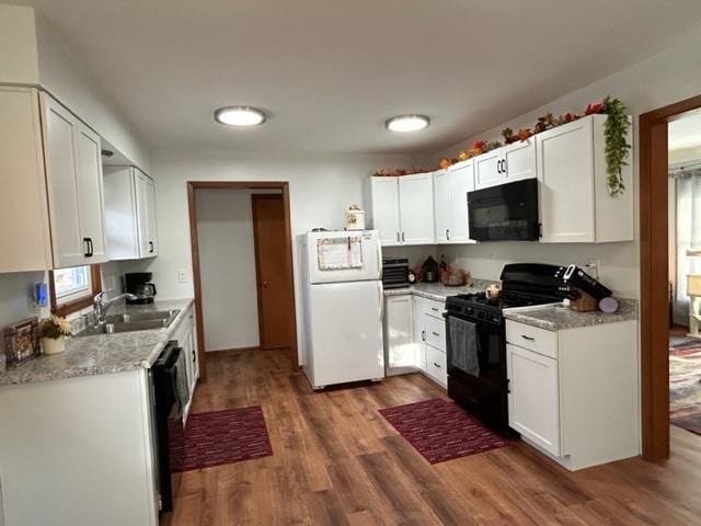 kitchen featuring white cabinetry, sink, dark hardwood / wood-style flooring, and black appliances