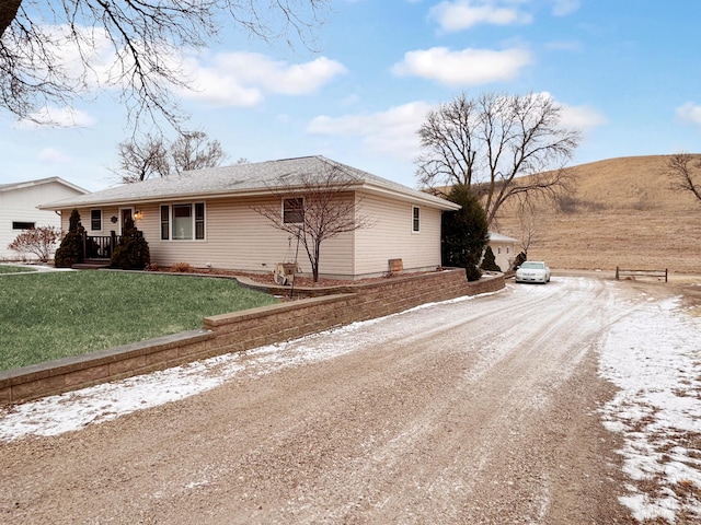 snow covered property featuring a lawn