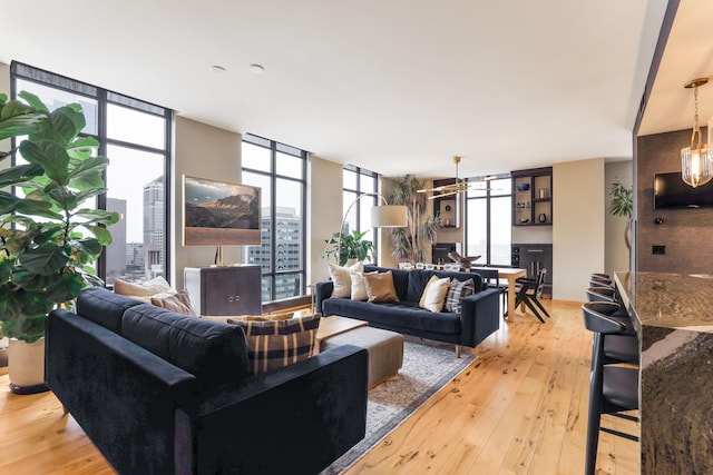 living room with floor to ceiling windows and light hardwood / wood-style floors