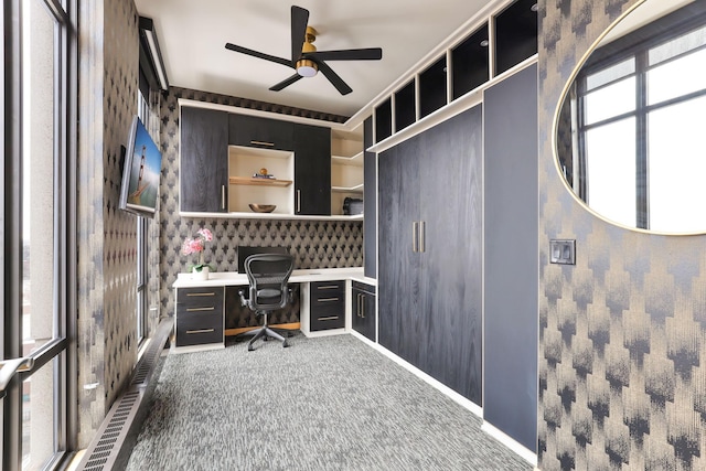 office space with ceiling fan, built in desk, and carpet floors