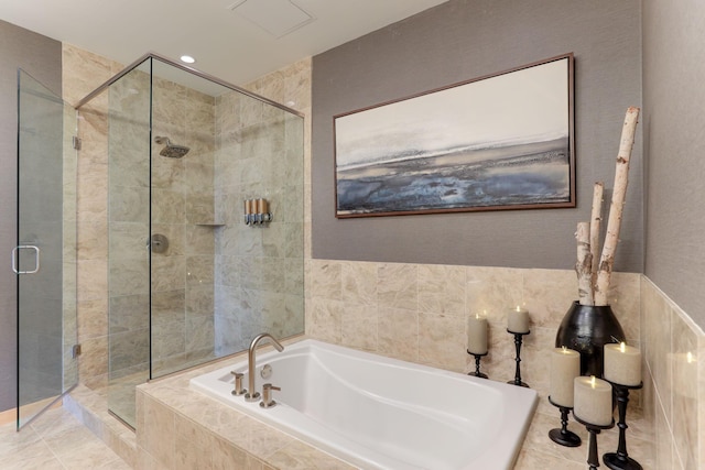 bathroom featuring tile walls and plus walk in shower