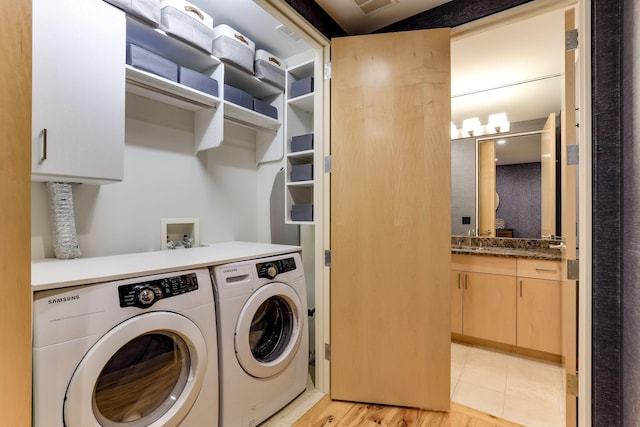 laundry area featuring separate washer and dryer and sink