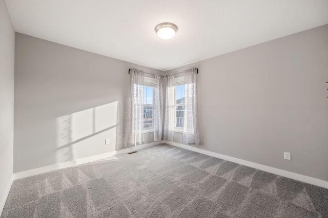 unfurnished room with carpet flooring