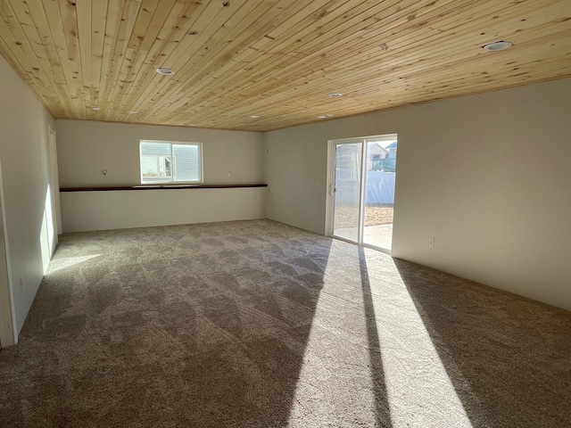 carpeted empty room with wood ceiling