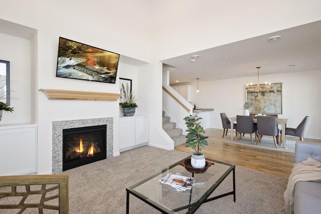 living room featuring light colored carpet and a notable chandelier