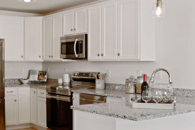 kitchen with white cabinets and appliances with stainless steel finishes