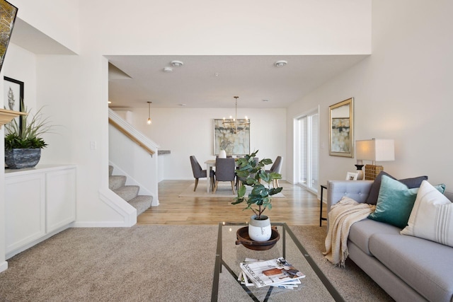 living room with light carpet and a notable chandelier