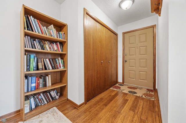 interior space featuring a textured ceiling and light hardwood / wood-style floors