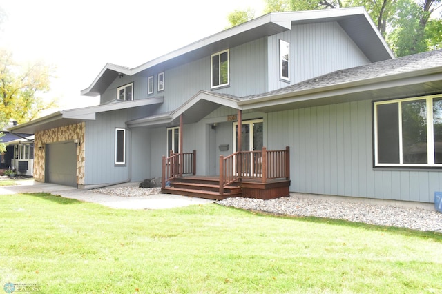 view of front of property featuring a garage and a front lawn