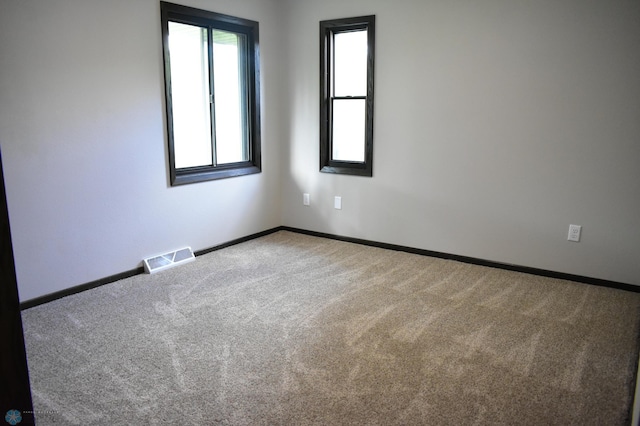 unfurnished room with carpet flooring