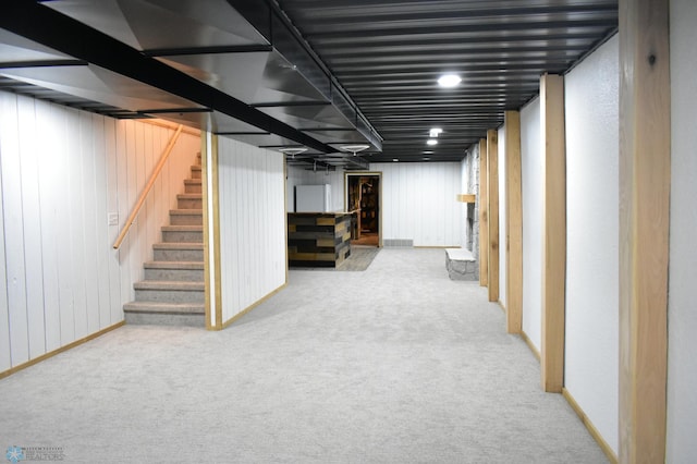 basement featuring light carpet