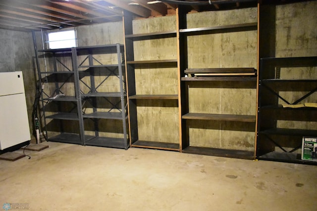 basement featuring white fridge