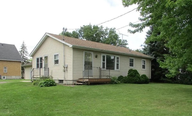 rear view of house featuring a lawn