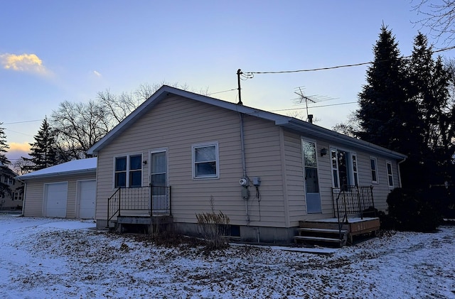 view of snowy exterior with a garage