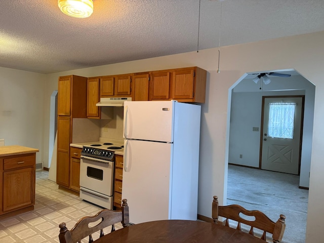 kitchen featuring ceiling fan, white appliances, and a textured ceiling