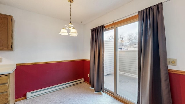 dining area with a chandelier and a baseboard heating unit