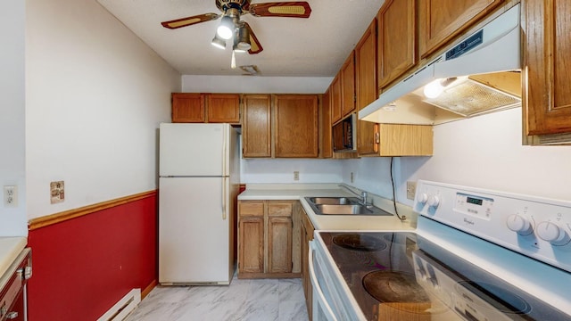 kitchen featuring ceiling fan, white appliances, a baseboard radiator, and sink