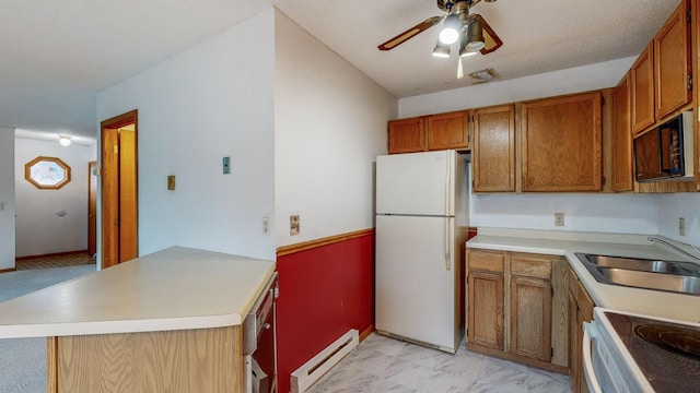 kitchen with sink, baseboard heating, ceiling fan, kitchen peninsula, and white appliances