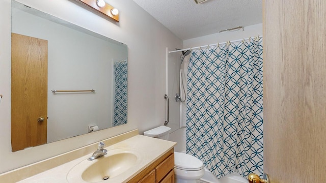 bathroom with vanity, a textured ceiling, and toilet