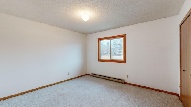 unfurnished bedroom with a baseboard radiator, carpet floors, a textured ceiling, and a closet