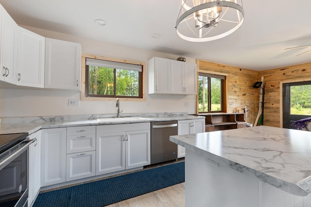 kitchen featuring white cabinetry, sink, stainless steel appliances, and a healthy amount of sunlight