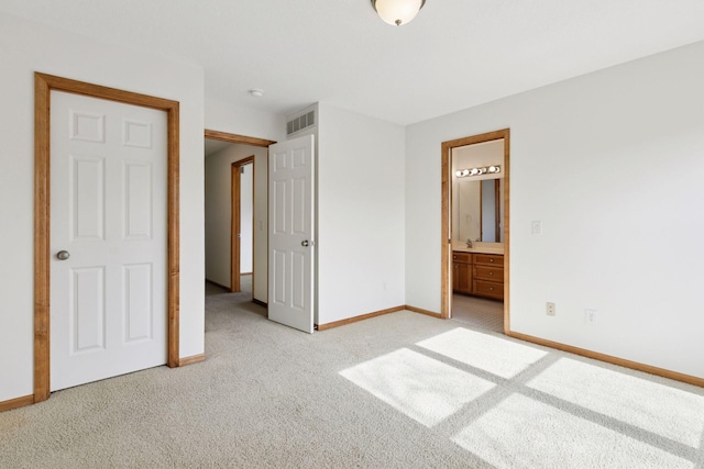 unfurnished bedroom with baseboards, visible vents, connected bathroom, light colored carpet, and a sink