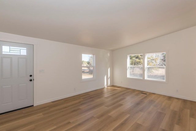 entryway featuring hardwood / wood-style flooring and vaulted ceiling