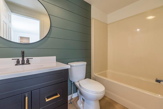 full bathroom with vanity, wooden walls, shower / bathtub combination, and toilet