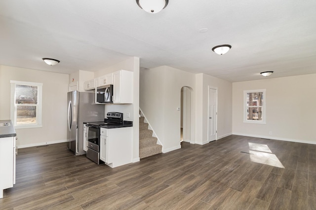 kitchen featuring white cabinetry, dark wood-type flooring, and stainless steel appliances