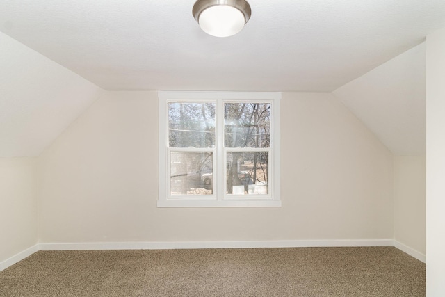 additional living space with lofted ceiling and carpet flooring