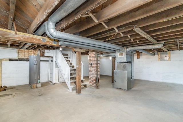 basement with heating unit, electric panel, and water heater