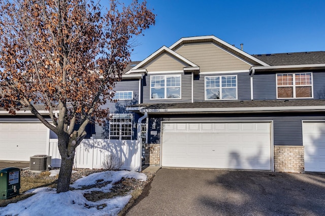 view of front of home featuring a garage and central air condition unit