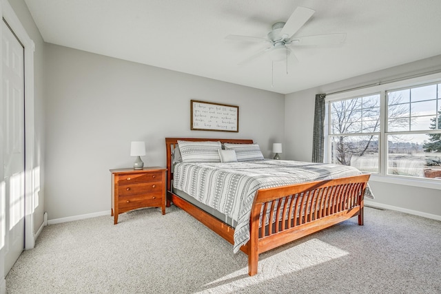 carpeted bedroom featuring a closet and ceiling fan