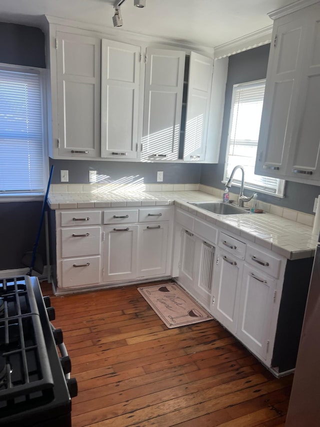 kitchen featuring sink, tile countertops, white cabinets, and dark wood-type flooring