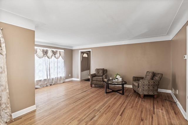 sitting room featuring hardwood / wood-style floors and ornamental molding