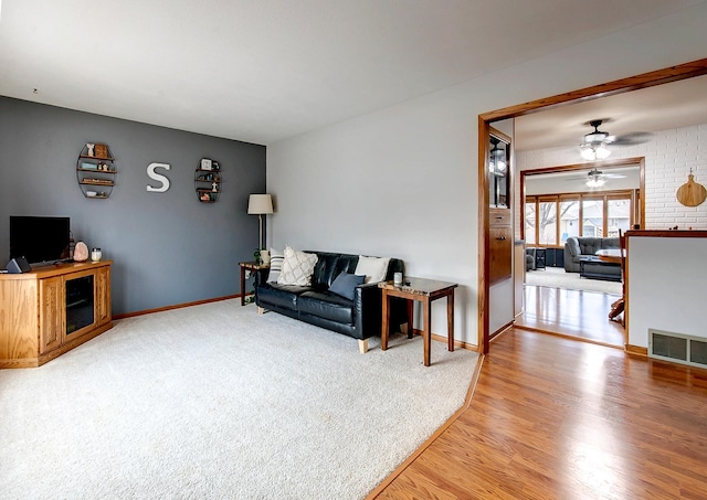 living room with ceiling fan and wood-type flooring