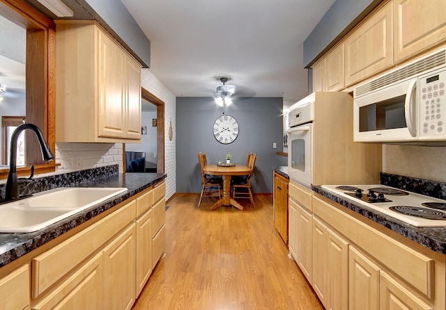 kitchen with sink, white appliances, light hardwood / wood-style flooring, ceiling fan, and light brown cabinetry