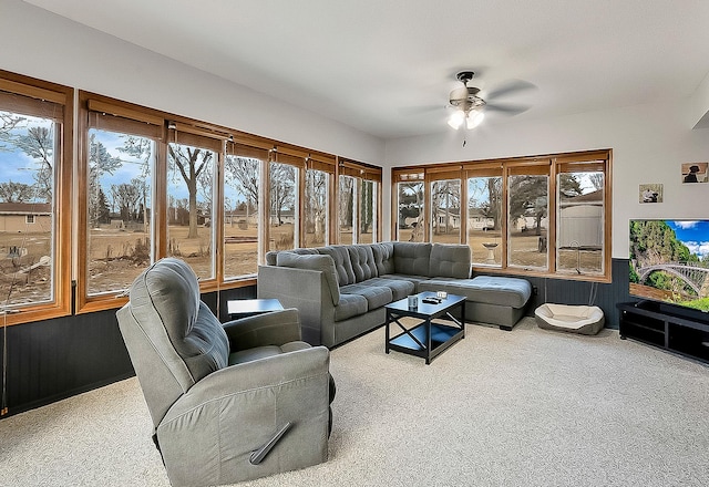 carpeted living room with plenty of natural light and ceiling fan